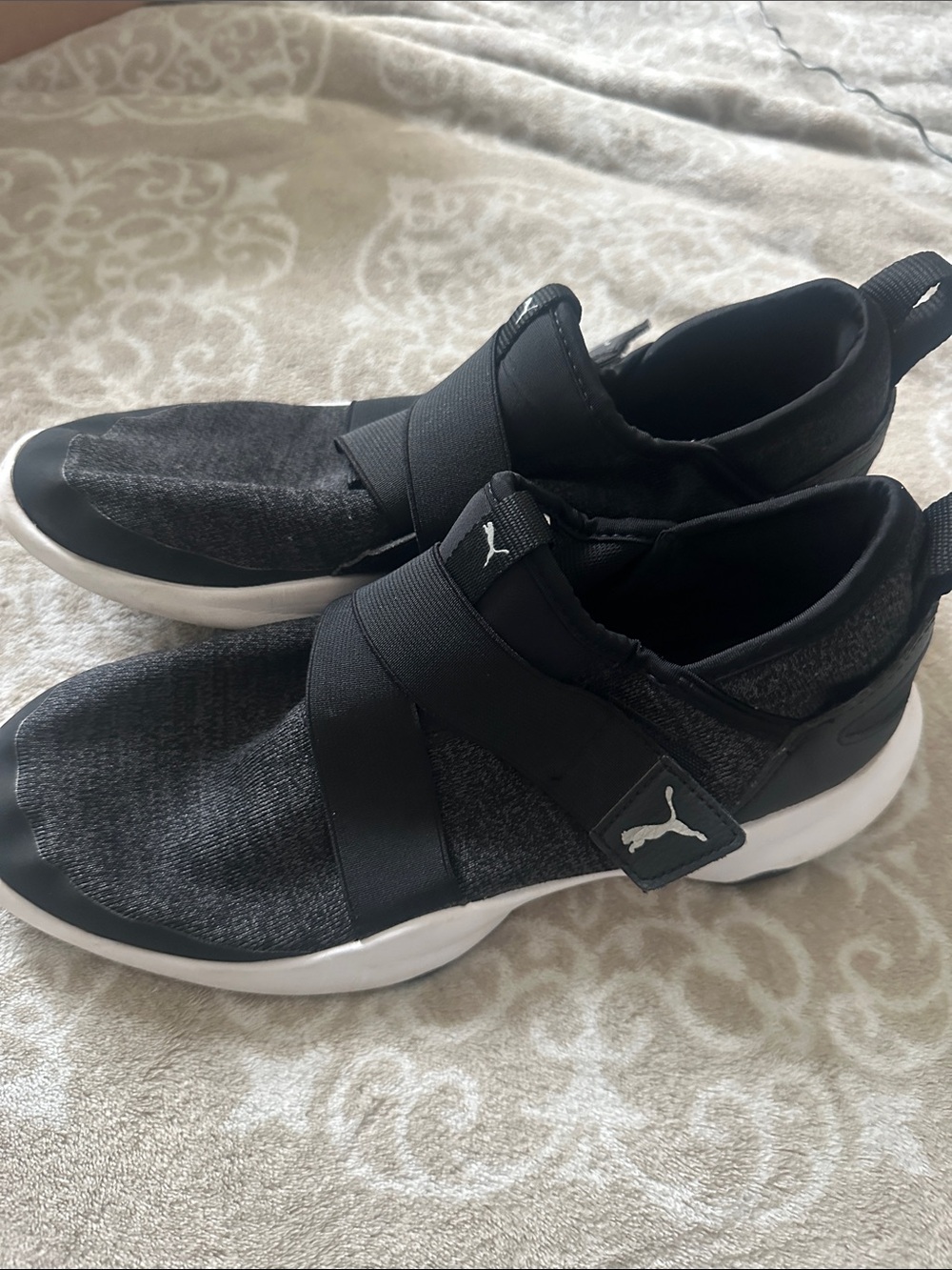 Puma women’s Black Slip-On Sneakers with White Soles